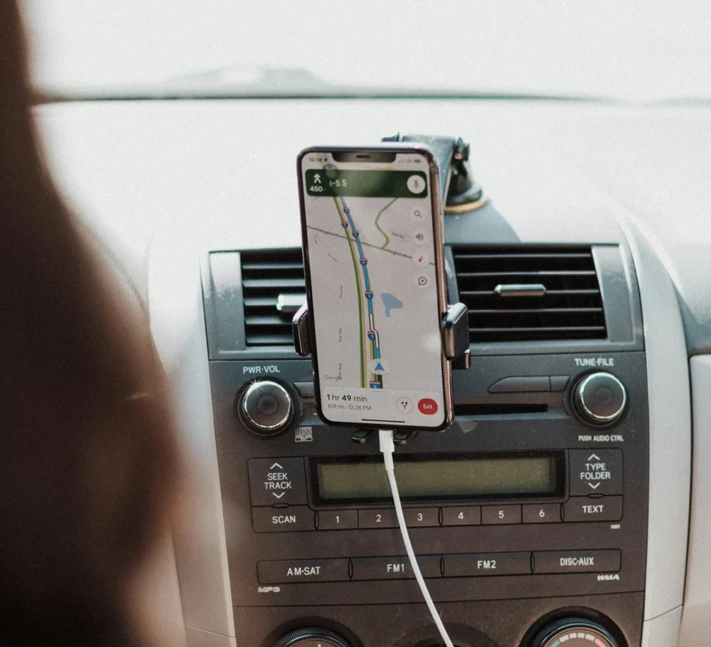 Phone on a car dashboard showing driving directions