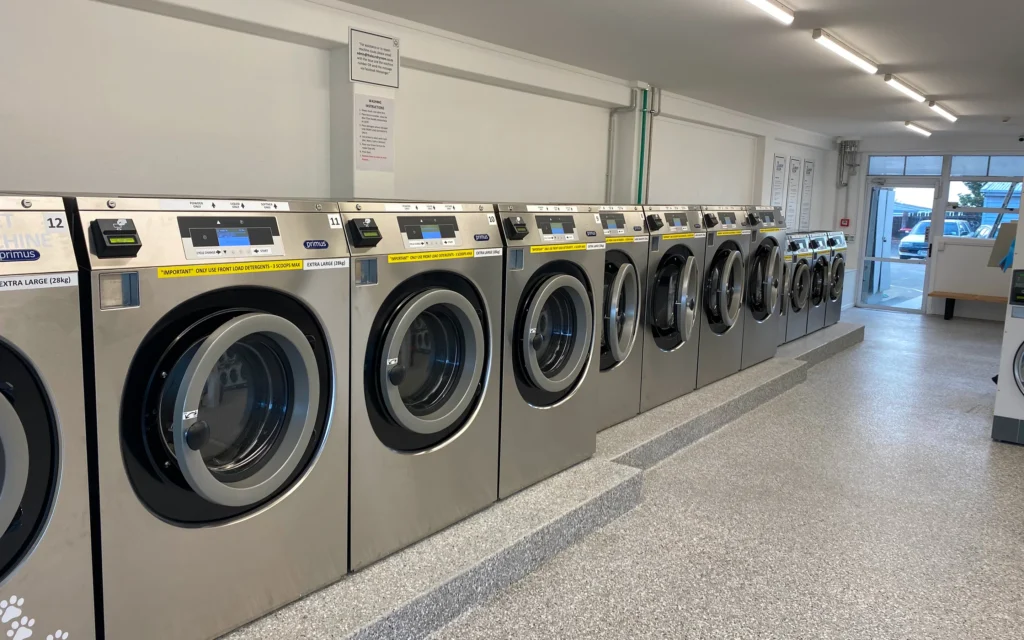 Row of front-loading washers at The Laundry Room Katikati