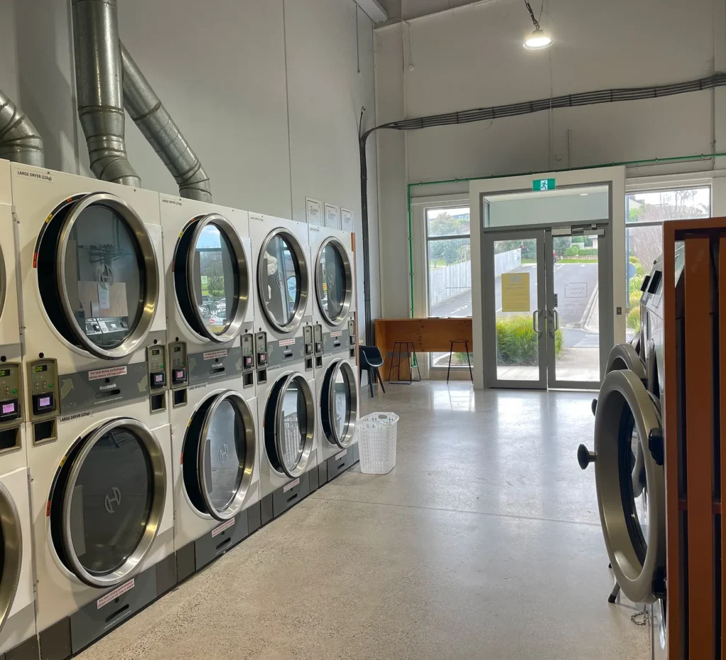 Stacked dryers beside the front entrance at our Ōmokoroa laundromat
