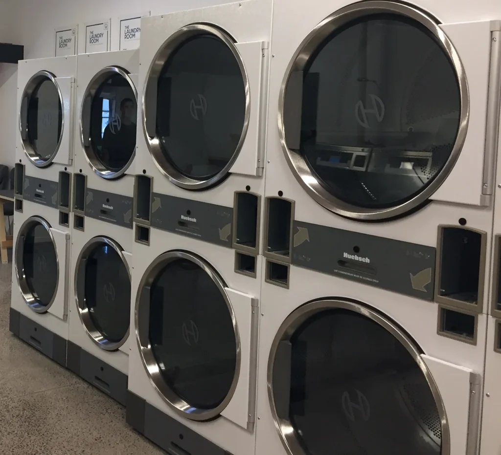 Large stacked dryers at our Welcome Bay laundromat in Tauranga