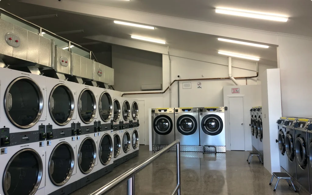 Rows of dryers and front-loading washers at The Laundry Room Main Street, Palmerston North