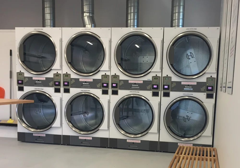 Wall of stacked dryers at The Laundry Room Welcome Bay, Tauranga